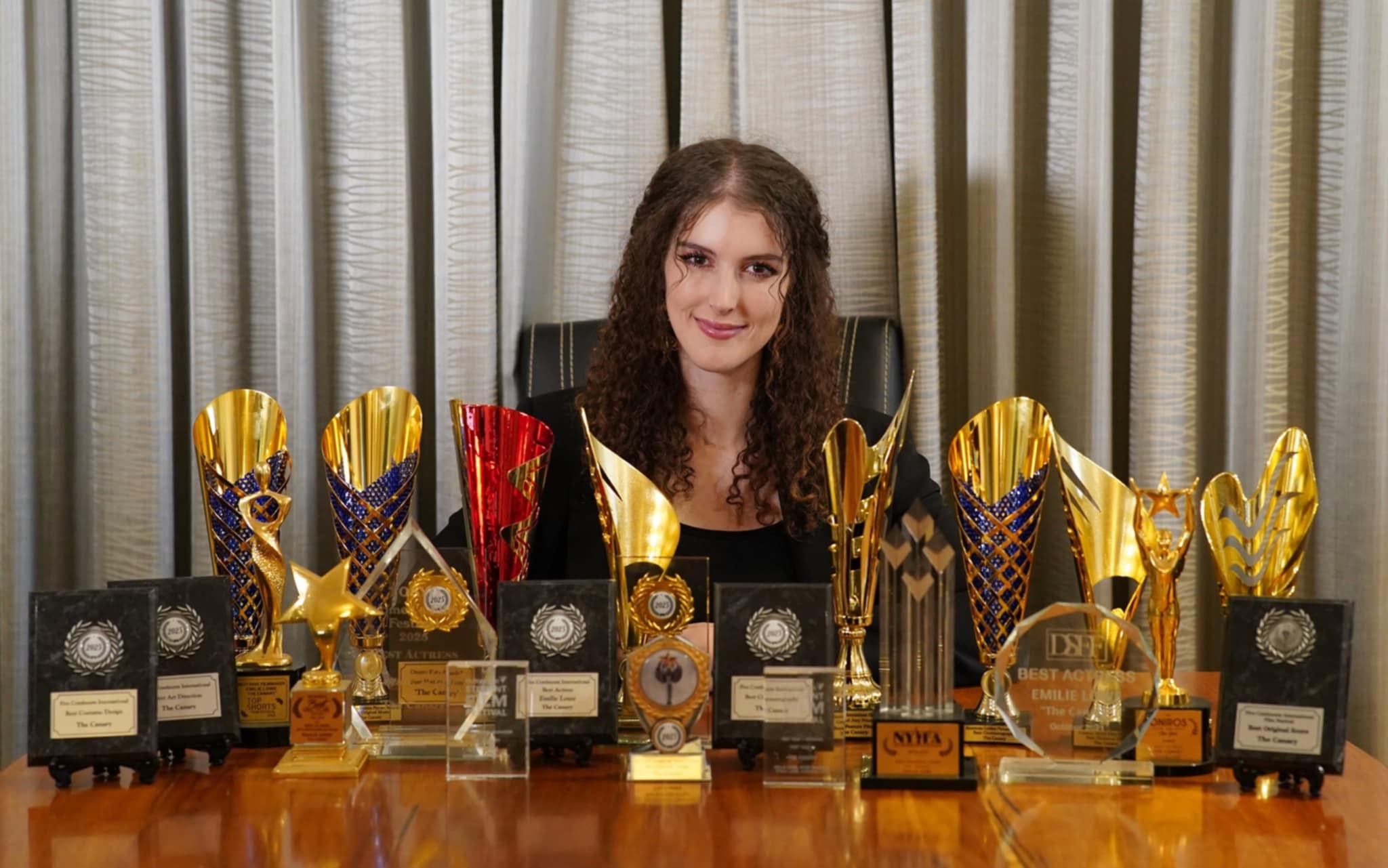 Director Emilie Lowe with the film’s awards 2025